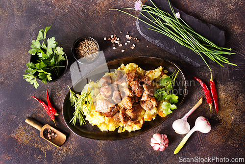 Image of Meat with prunes, goulash and mashed potatoes