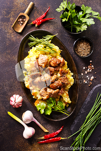 Image of Meat with prunes, goulash and mashed potatoes