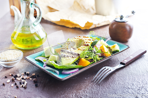 Image of Fresh salad with avocado in a bowl. Healthy vegetarian dish