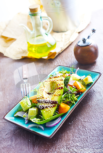 Image of Fresh salad with avocado in a bowl. Healthy vegetarian dish