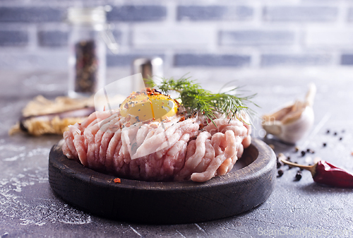 Image of Raw minced chicken fillet, uncooked meat over board