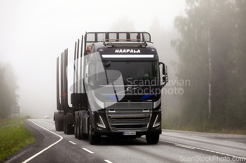 Image of New Volvo FH16 Logging Truck on Road in Autumn Fog