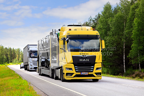 Image of Yellow MAN TGX Car Carrier in Highway Truck Traffic