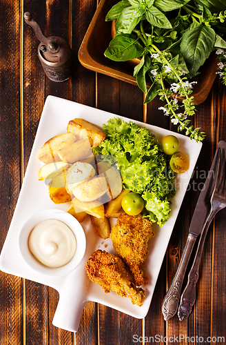 Image of roasted chicken wings with potato