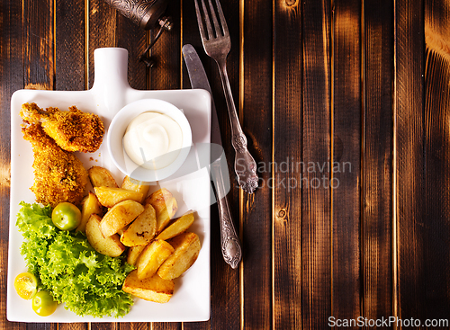 Image of roasted chicken wings with potato