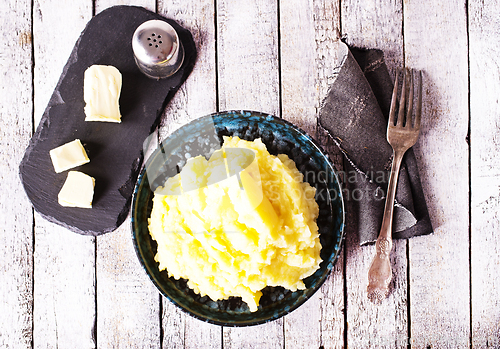 Image of Bowl of tasty mashed potatoes with butter