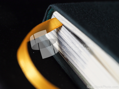 Image of Yellow bookmark in a green book