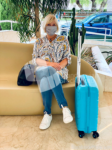 Image of blonde tourist sitting at the hotel