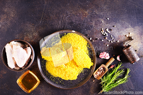 Image of chicken wings with panko in a gray ceramic bowl on a rustic table ready to cooking