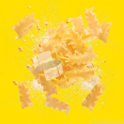 Image of Mafaldine pasta flying with flour