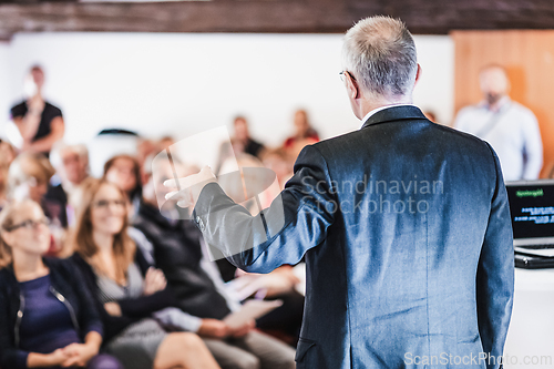 Image of Speaker at Business Conference and Presentation.
