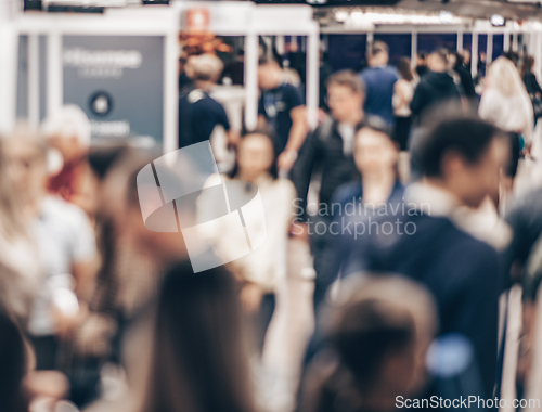 Image of Abstract blurred people at exhibition hall of expo event trade show. Business convention show or job fair. Business concept background.