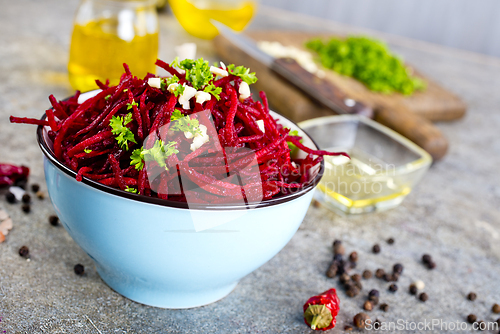 Image of delicious fresh beet salad on gray stone background.