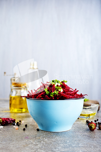 Image of delicious fresh beet salad on gray stone background.