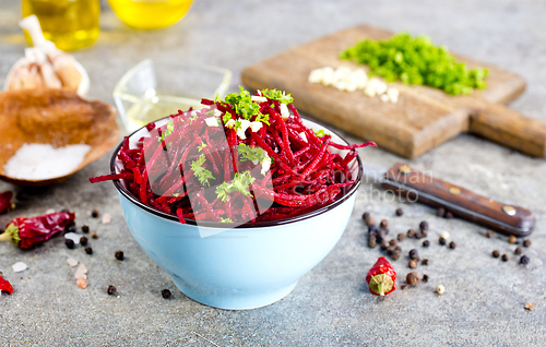 Image of delicious fresh beet salad on gray stone background.
