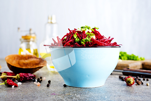 Image of delicious fresh beet salad on gray stone background.