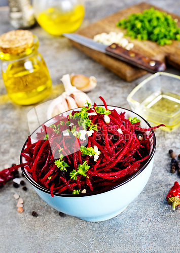 Image of delicious fresh beet salad on gray stone background.