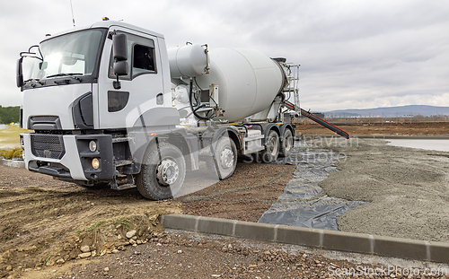 Image of Concrete mixer truck pouring cement
