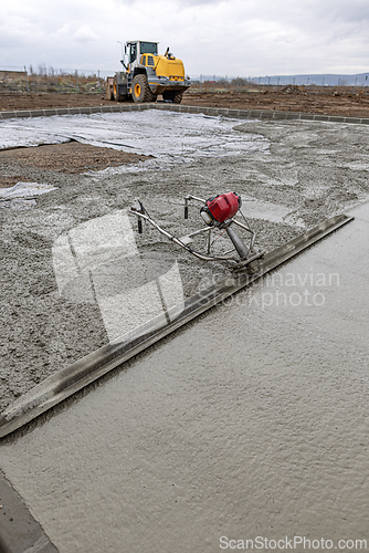 Image of Construction workers using power screed