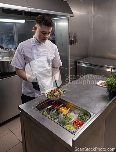 Image of Chef making colorful salad
