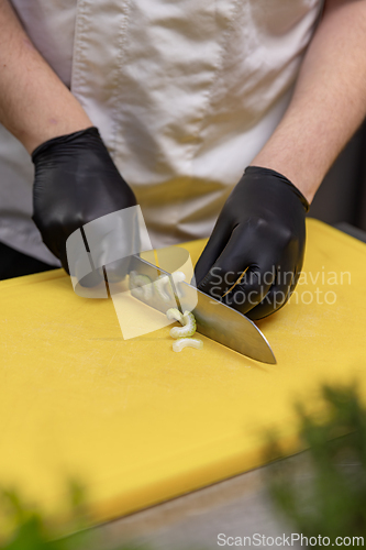 Image of Chef slicing celery