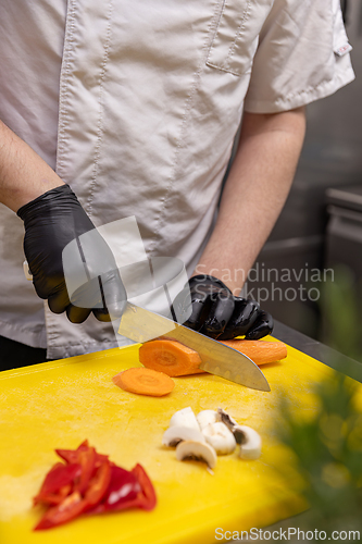 Image of Chef slicing fresh carrot