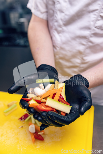 Image of Chef presenting chopped vegetables