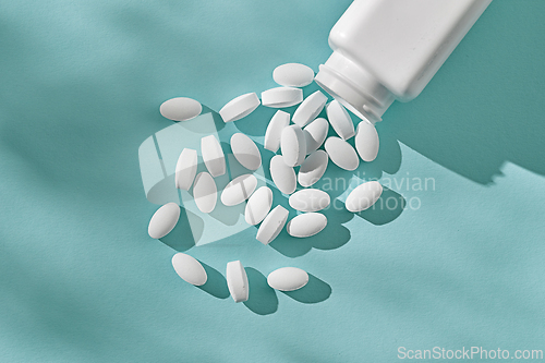 Image of white pills on blue background