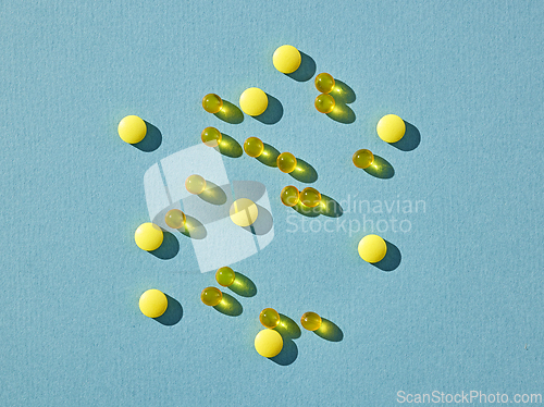 Image of yellow pills on blue background