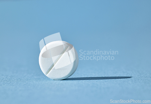 Image of white pill on blue background