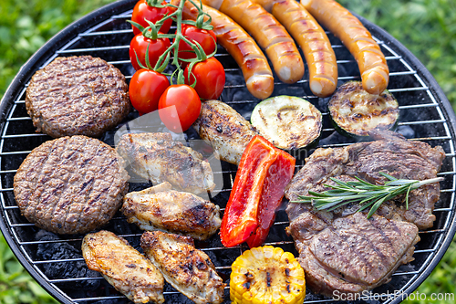 Image of various meat and vegetables on grill