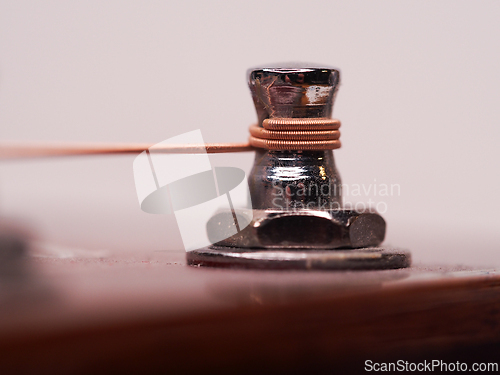 Image of Detail of a fastened guitar string