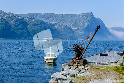 Image of Majestic fjord view in Norway with a peaceful boat navigating th