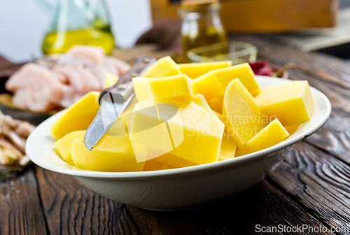 Image of raw potato and chicken on wooden table