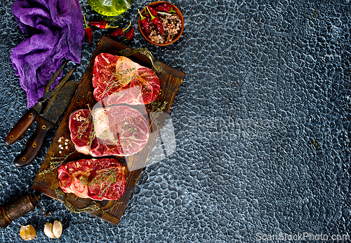 Image of A few steak pieces on the wooden board on a table