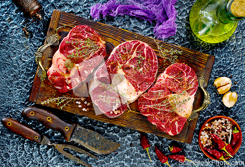 Image of A few steak pieces on the wooden board on a table