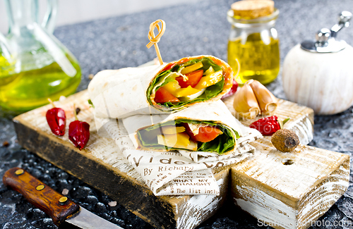 Image of Shawarma sandwich with vegetable and cheese. Traditional Middle Eastern snack. On wooden background