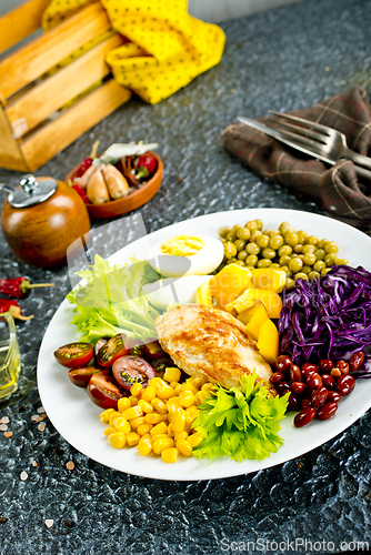 Image of Plate of salad. Salad, healthy food consist of lettuce, tomatoes, corn, carrot, boiled egg, chicken