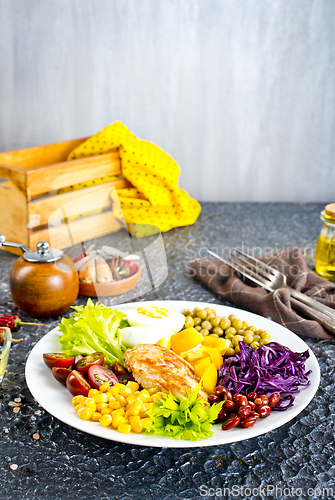 Image of Plate of salad. Salad, healthy food consist of lettuce, tomatoes, corn, carrot, boiled egg, chicken