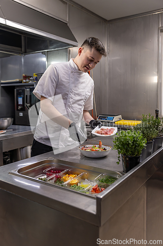 Image of Young chef preparing a healthy salad