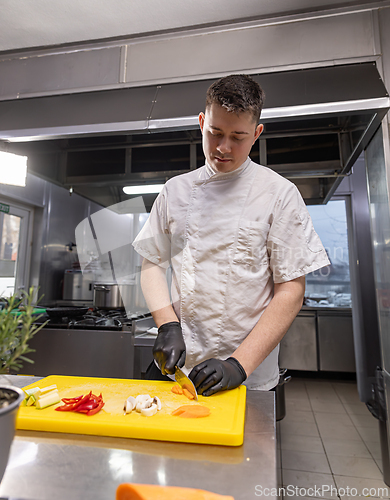 Image of Chef slicing fresh carrot
