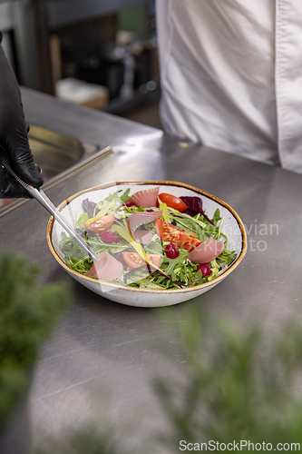 Image of Chef preparing a healthy salad with smoked salmon