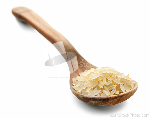 Image of raw rice in wooden spoon