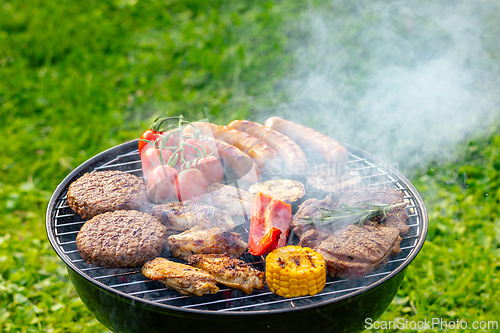Image of various meat and vegetables on grill