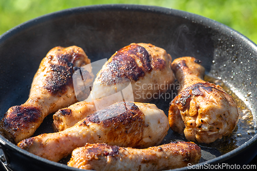 Image of chicken legs are fried on a pan
