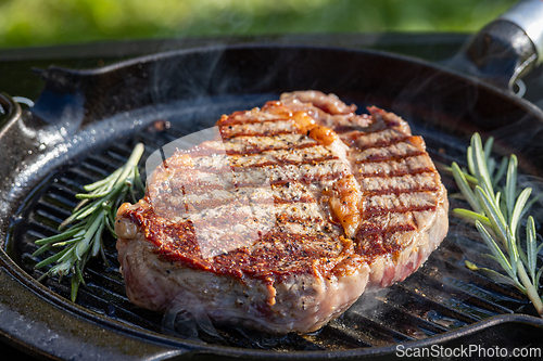 Image of beef steak on grilling pan