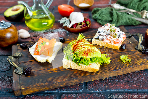 Image of Open sandwiches with salted salmon, guacamole avocado and microgreens.