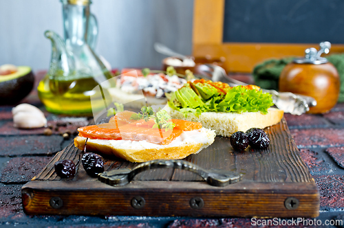 Image of Open sandwiches with salted salmon, guacamole avocado and microgreens.