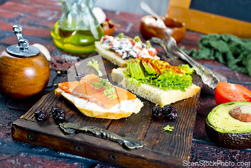 Image of Open sandwiches with salted salmon, guacamole avocado and microgreens.