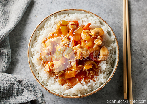 Image of bowl of boiled rice with sweet and sour sauce
